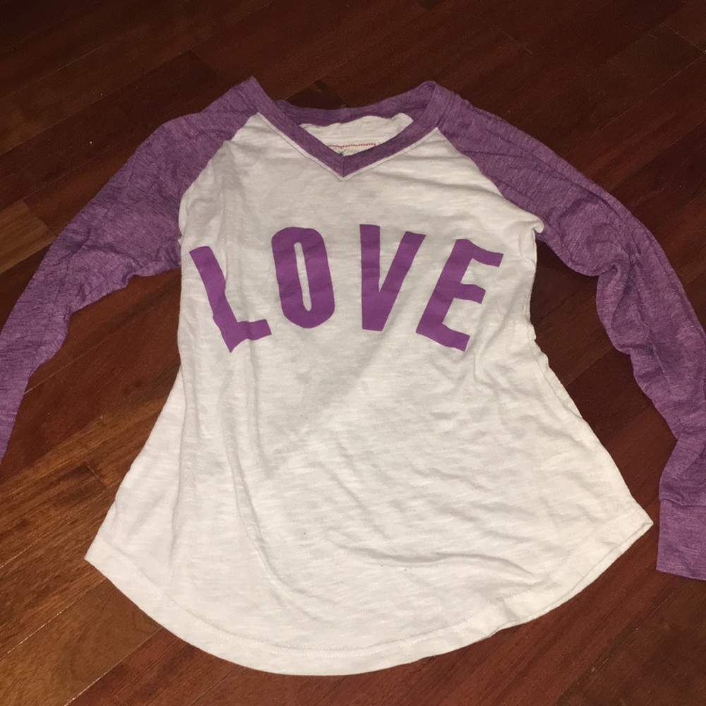 White and purple baseball tee with “LOVE” written